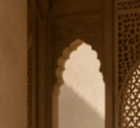Sunlight through a carved sandstone arch and jaali screen