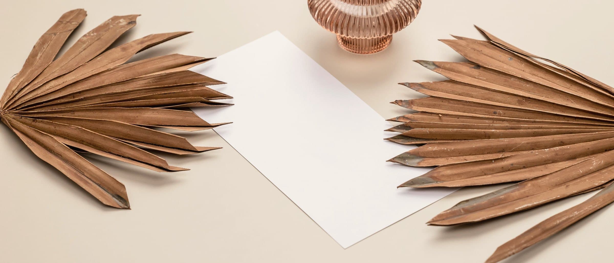 Plain kraft paper parcels and folded card in soft daylight